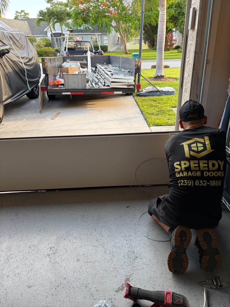 Technician Preparing a Garage Door Panel — garage door repair Naples FL